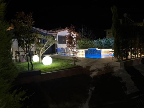 a backyard with a pool at night at Villa REJA Hamallaj in Draçi