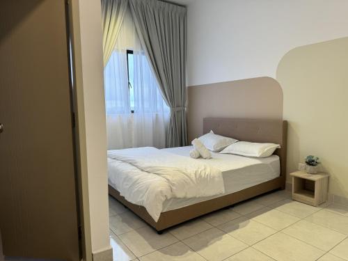 a bedroom with a bed and a window at Youth City in Nilai