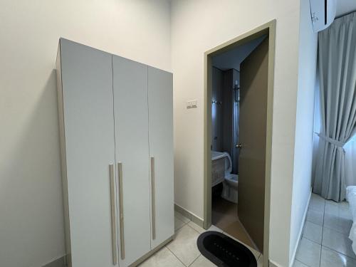 a room with a white cabinet and a bathroom at Youth City in Nilai