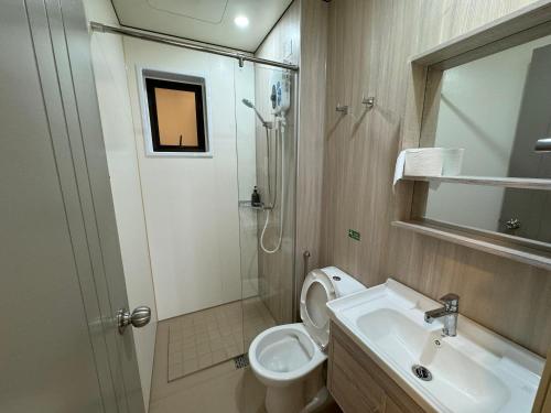 a bathroom with a toilet and a sink and a shower at Youth City in Nilai