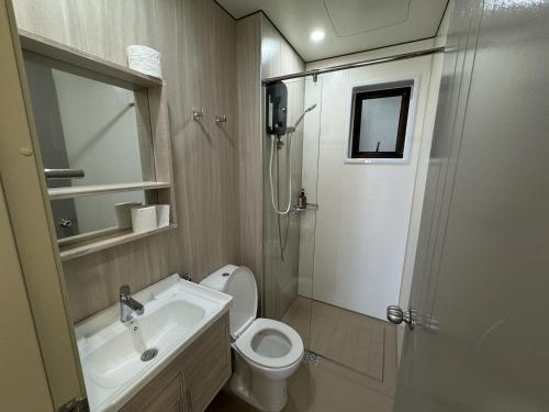 a bathroom with a toilet and a sink and a shower at Youth City in Nilai