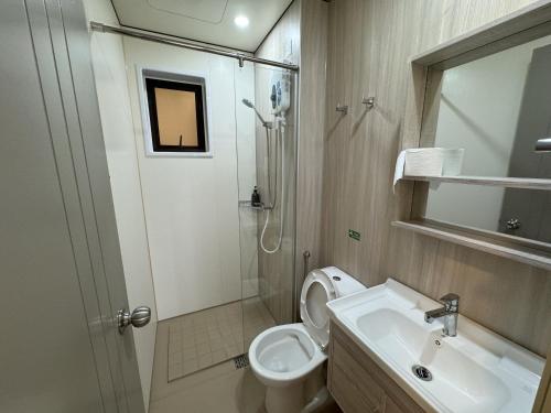 a bathroom with a toilet and a sink and a shower at Youth City in Nilai