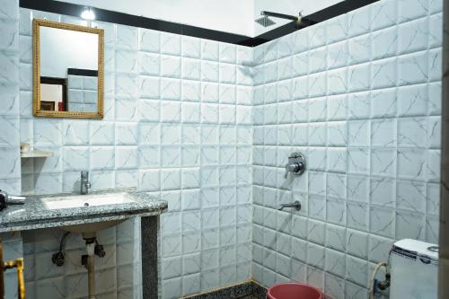 a bathroom with a sink and a mirror at Hotel The Surya Jaisalmer in Jaisalmer