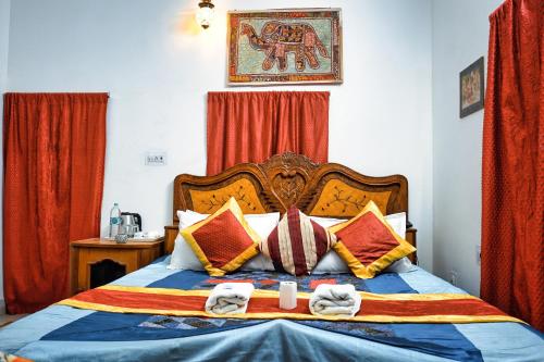 a bedroom with a bed with towels on it at Hotel The Surya Jaisalmer in Jaisalmer
