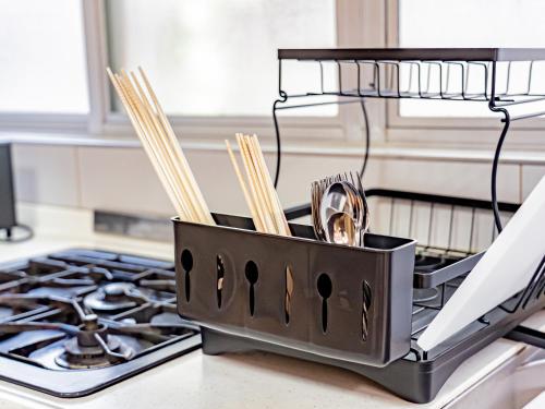a container of utensils sitting on top of a stove at The M OTAMACHI in Nakatsugawa