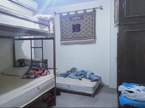 a room with two bunk beds and a blanket at Cairo , New Nozha in Cairo