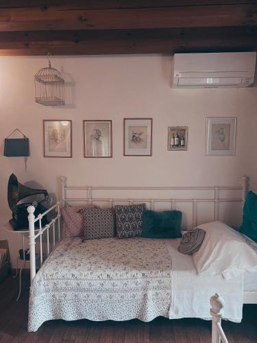 a bedroom with a bed and a bird cage on the wall at Locanda San Tomaso in Treviso