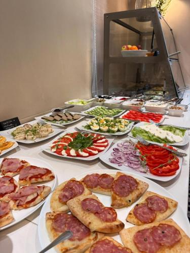 a buffet with many plates of food on a table at Hotel Gorczowski Katowice Chorzów in Chorzów