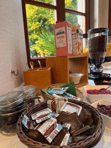 a counter with a basket of food on a table at Hotel Gorczowski Katowice Chorzów in Chorzów