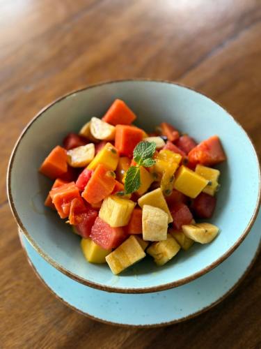 a bowl of vegetables on a wooden table at Daffodil Restaurant & Holiday Resort in Unawatuna