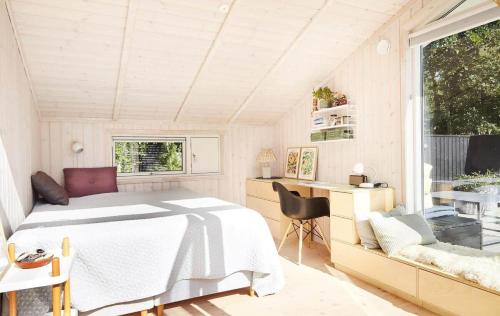 a bedroom with a bed and a desk and a window at 10017-1-Rorvig-Birkealle-2 in Rørvig