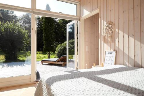 a bedroom with a bed and a large window at 10017-1-Rorvig-Birkealle-2 in Rørvig