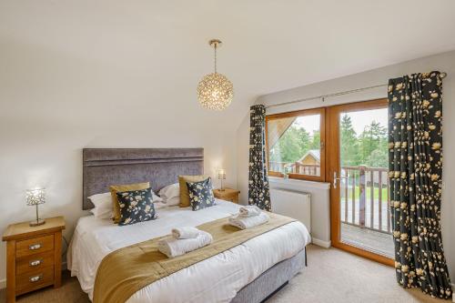 Lord Galloway 33 with Hot Tub في نيوتن ستيوارت: غرفة نوم بسرير كبير ونافذة