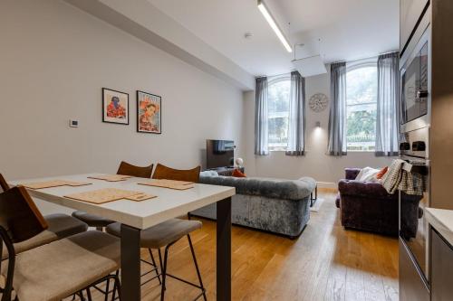 a living room with a table and a couch at Modern City Centre Apartment in Nottingham