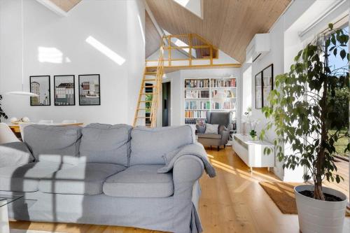 a living room with a couch and a table at 16632-Farevejle-Karuphoj-4-C in Fårevejle