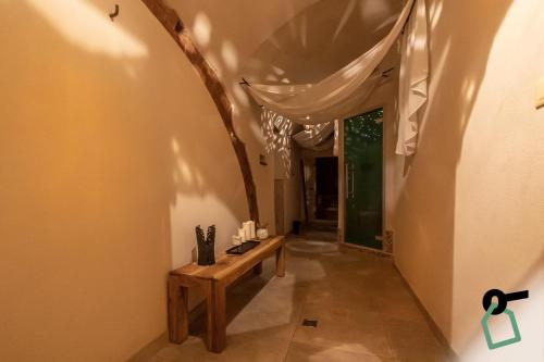 a hallway with a wooden bench in a room at Hotiday Vezzano Ligure in La Spezia