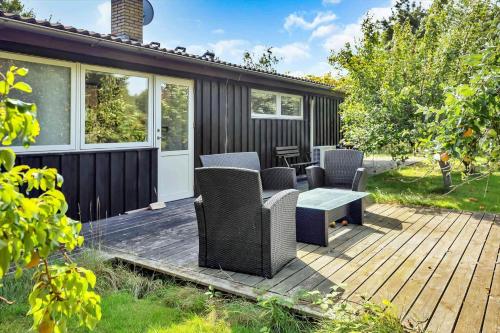 a patio with chairs and a table on a deck at 18008-Holbaek-Raevestien-5 in Holbæk
