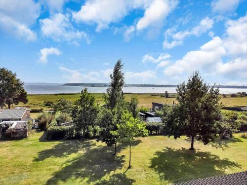 an aerial view of a house with trees and the water at 18008-Holbaek-Raevestien-5 in Holbæk
