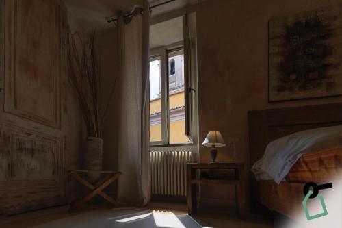 a bedroom with a bed and a window at Hotiday Vezzano Ligure in La Spezia