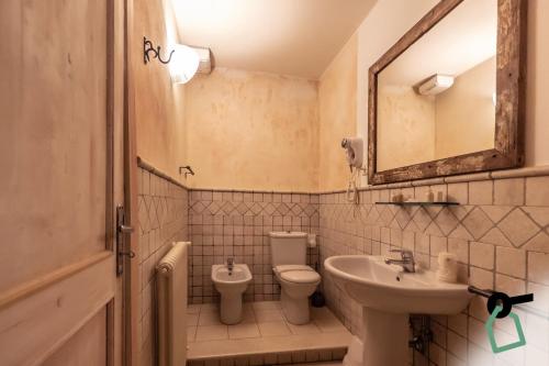 a bathroom with a sink and a toilet and a mirror at Hotiday Vezzano Ligure in La Spezia