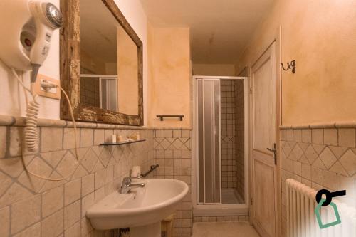 a bathroom with a sink and a mirror at Hotiday Vezzano Ligure in La Spezia