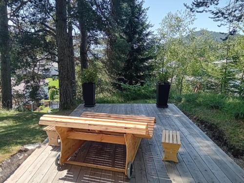 a wooden picnic table sitting on a wooden deck at Landhaus Almidyll in Seefeld in Tirol
