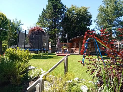 a playground with a slide in a yard at Landhaus Almidyll in Seefeld in Tirol
