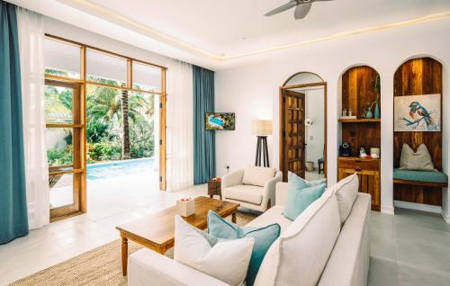 a living room with a couch and a table at Kisiwa on the Beach in Paje