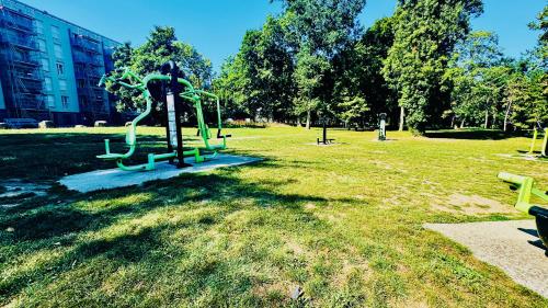 a park with a statue in the grass at Coeur de Dammarie - Balcon et Parking privé in Dammarie-lès-Lys