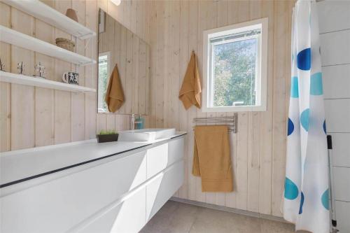 a bathroom with a tub and a sink and a window at 13370-Hojby-Havsbjergvej-11-A in Højby