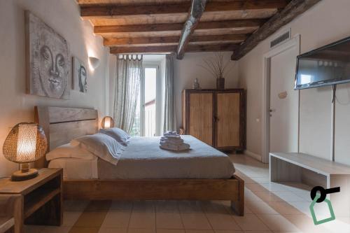 a bedroom with a bed and a television in it at Hotiday Vezzano Ligure in La Spezia