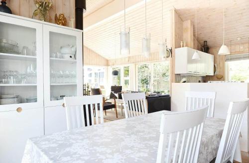 a kitchen and dining room with a table and chairs at 13392-Hojby-Herlufholmsvej-13 in Højby