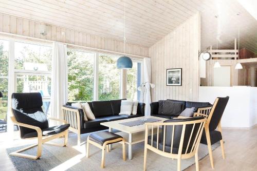 a living room with a couch and chairs and a table at 13392-Hojby-Herlufholmsvej-13 in Højby