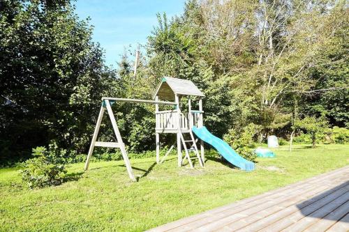 a playground with a slide in the grass at 13392-Hojby-Herlufholmsvej-13 in Højby