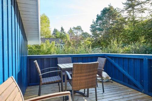 a patio with a table and chairs on a deck at 13392-Hojby-Herlufholmsvej-13 in Højby
