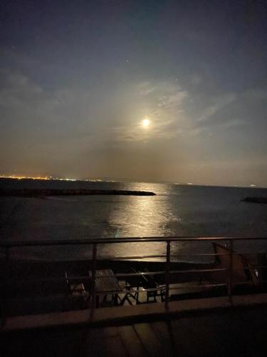 a view of the ocean from a boat at night at Ayvalik Seafront Villa Mansion Summer House in Ayvalik in Ayvalık