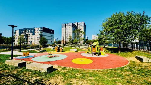 a park with a playground in a city at Coeur de Dammarie - Balcon et Parking privé in Dammarie-lès-Lys