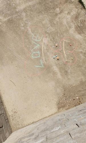 a sidewalk with some graffiti on the ground at ROLA - smeštaj in Paraćin