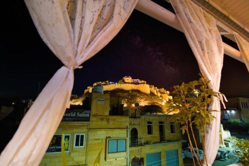 a building with a castle on top of it at Hotel The Surya Jaisalmer in Jaisalmer