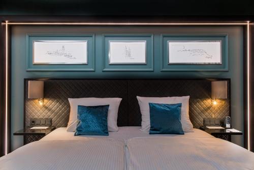 a bedroom with a large bed with blue walls at Best Western Plus Kurhotel an der Obermaintherme in Bad Staffelstein