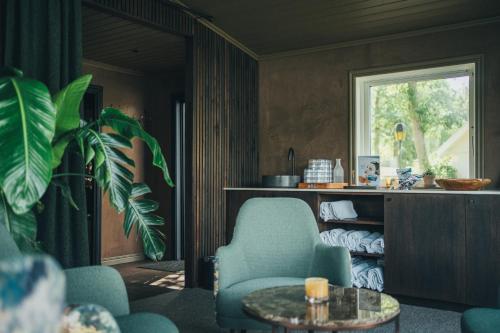 a living room with two chairs and a table at Hällsnäs Hotell & Restaurang in Mölnlycke