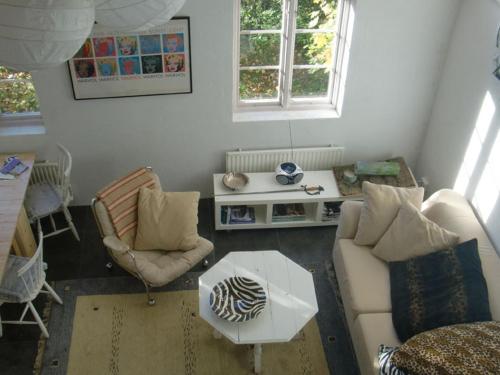 a living room with a couch and chairs and a table at Trolleberg Bed & Breakfast in Veberöd
