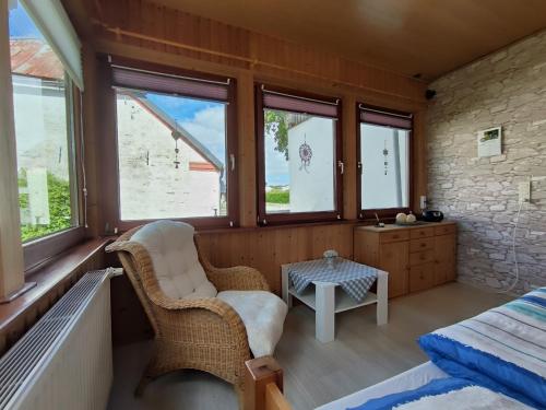 a room with a bed and a table and windows at Storchenblick in Sieverstedt - ebenerdige FeWo in ruhiger Umgebung in Sieverstedt