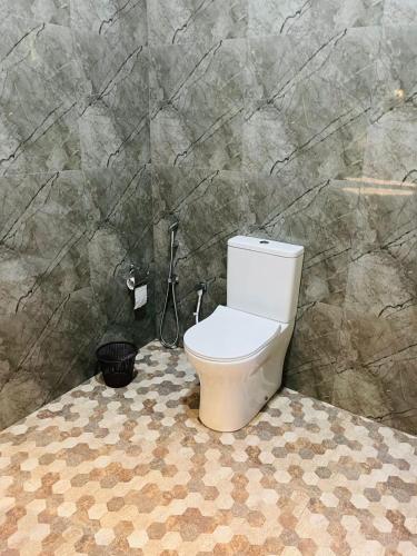 a bathroom with a toilet in a stone wall at Sigiri Bawana in Sigiriya