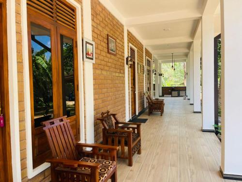 a hallway with rocking chairs on a house at Sigiri Bawana in Sigiriya