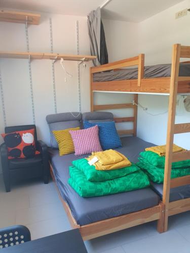 a bedroom with a bunk bed and a ladder at Far Away So Close Kropa near Bled Rooms in Kropa