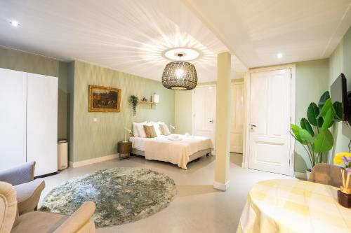 a bedroom with a bed and a living room at NEW! Modern Gallery Nassau Canal Suite in Amsterdam