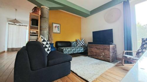a living room with a couch and a television at Casa Rossa in Montecassiano