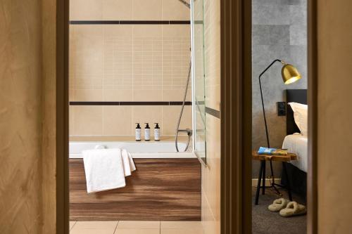 a bathroom with a shower with a bath tub at Hôtel L'Arboisie in Megève