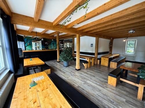 an empty restaurant with wooden tables and benches at EASY Lodges Berlin in Berlin